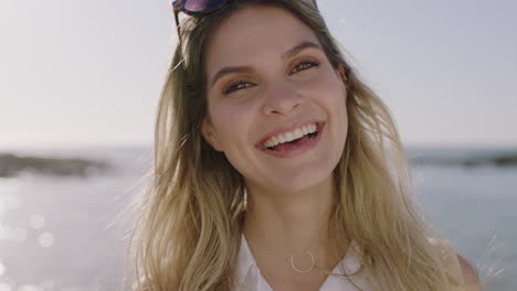 portrait of beautiful young woman laughing cheerful looking to camera enjoying sunny beach