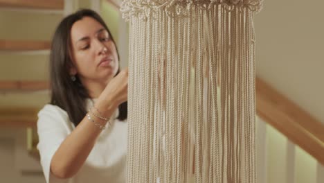 home hobby, knitting macrame. women's hands knit an ornament with thick threads.