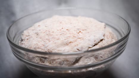 Bread-dough-slowly-spinning.-White-gray-background