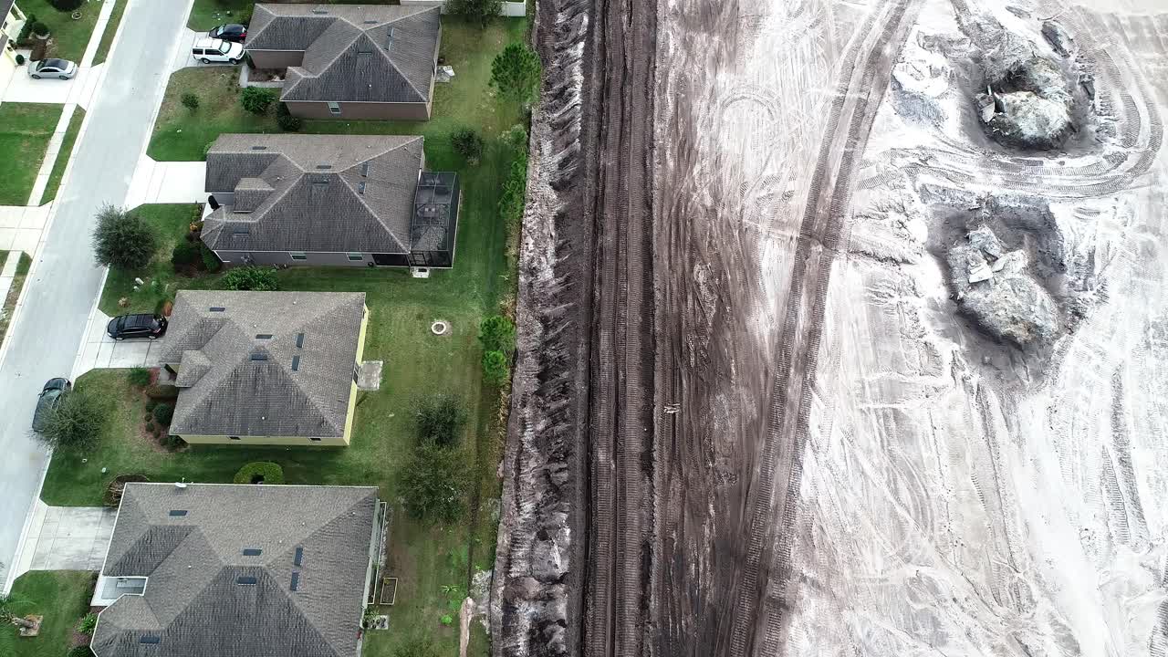 An aerial flyover of a residential site in land development phase to be built as a suburban single family residential development.