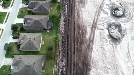 an aerial flyover of a residential site in land development phase to be built as a suburban single family residential development.