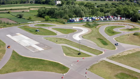 supercars driving on the race track of moto park training center in krakow, poland. - aerial shot