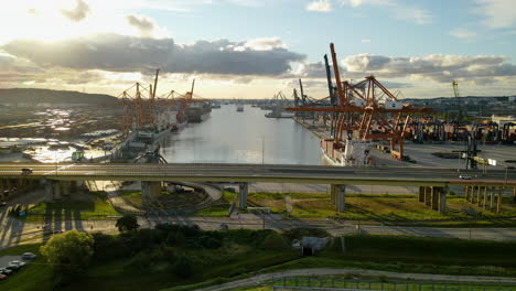 panoramic view with elevated highway and gdynia harbour and shipyard at background during sunset in poland