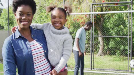 Portrait-of-happy-african-american-family-playing-football-in-park