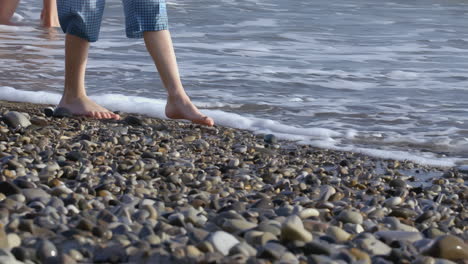 children's feet walking on the beach