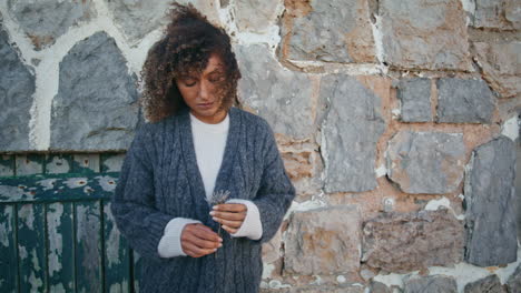 frustrated model posing ancient building wall leaning on rocked surface zoom on