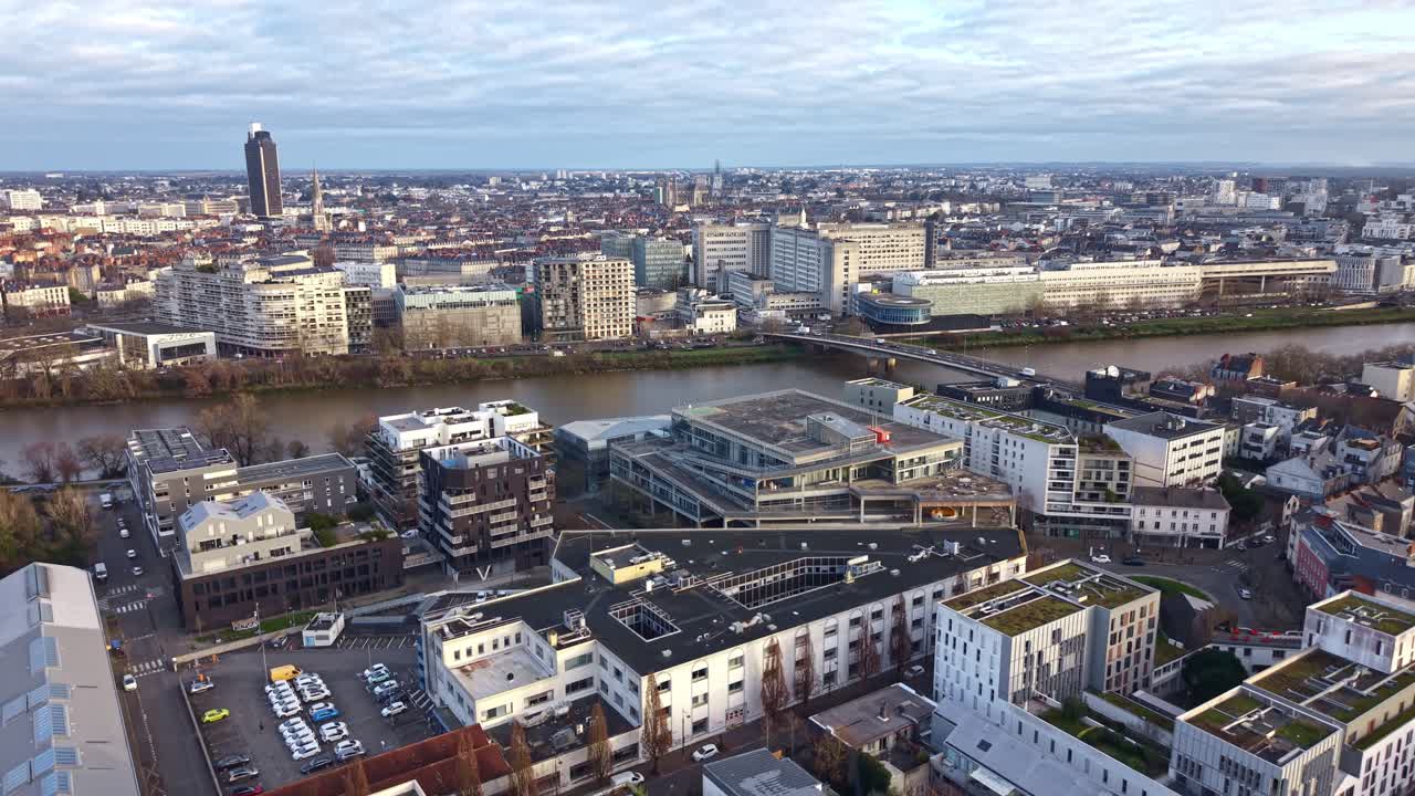 Cinematic aerial drone ascending view of the Nantes cityscape with the Loire River, Pont Haudaudine, hospital and Tour de Bretagne. France