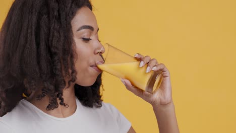 una mujer bebiendo jugo de naranja.