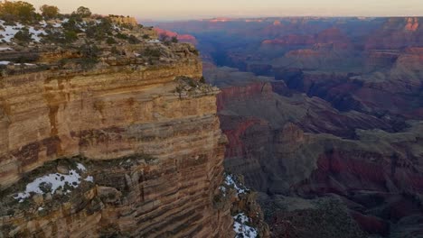 woman standing on the summit of the grand canyon and arches in arizona - drone flying forward