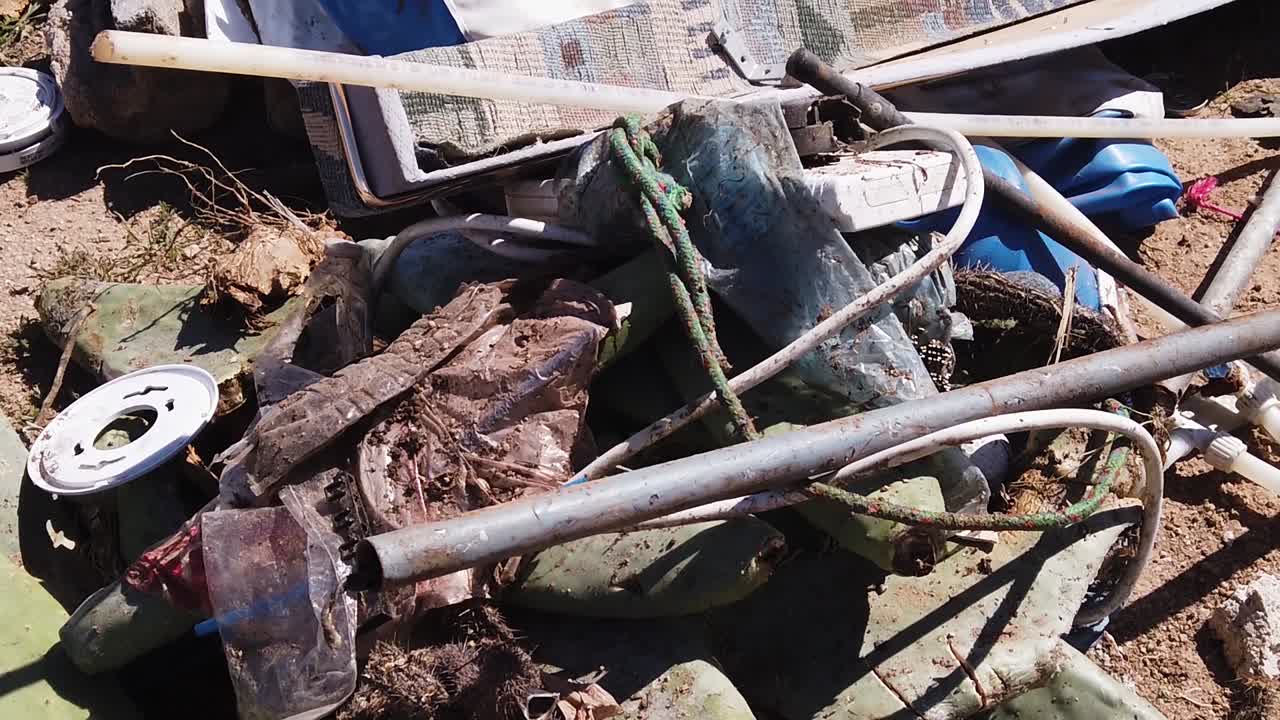 slow tilt-up on piles of trash scattered across the desert floor, Scottsdale, Arizona