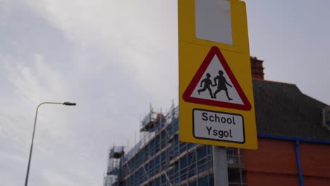 Welsh-crossing-sign-outside-of-a-school-in-Cardiff,-early-morning