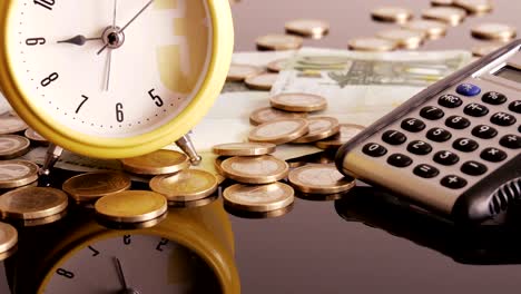 alarm clock on coins and banknotes