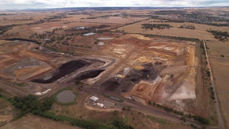 Small-open-cut-coal-mine-operation-circling-aerial,-Australia