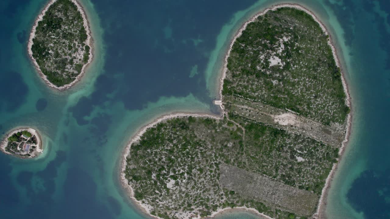 Aerial shot of Love Island glowing at sunset, heart-shaped, Galesnjak, Croatia
