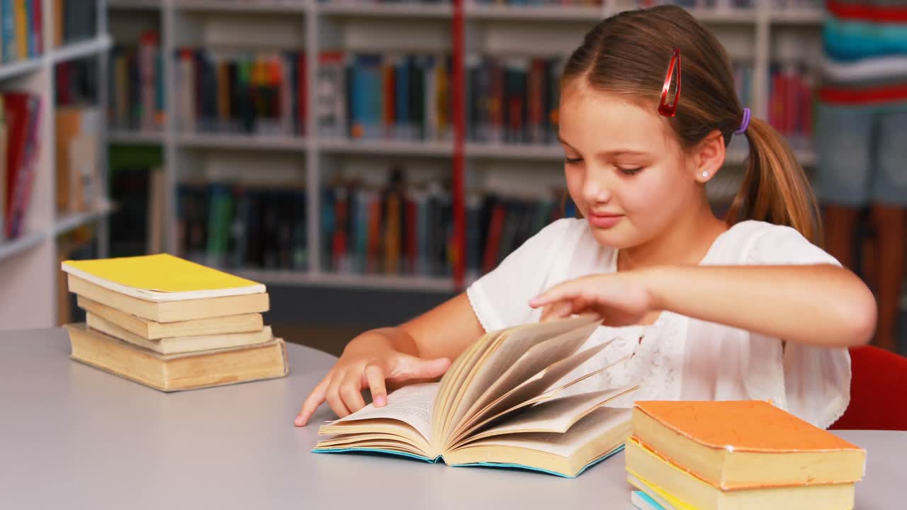 Schoolgirl reading book in library