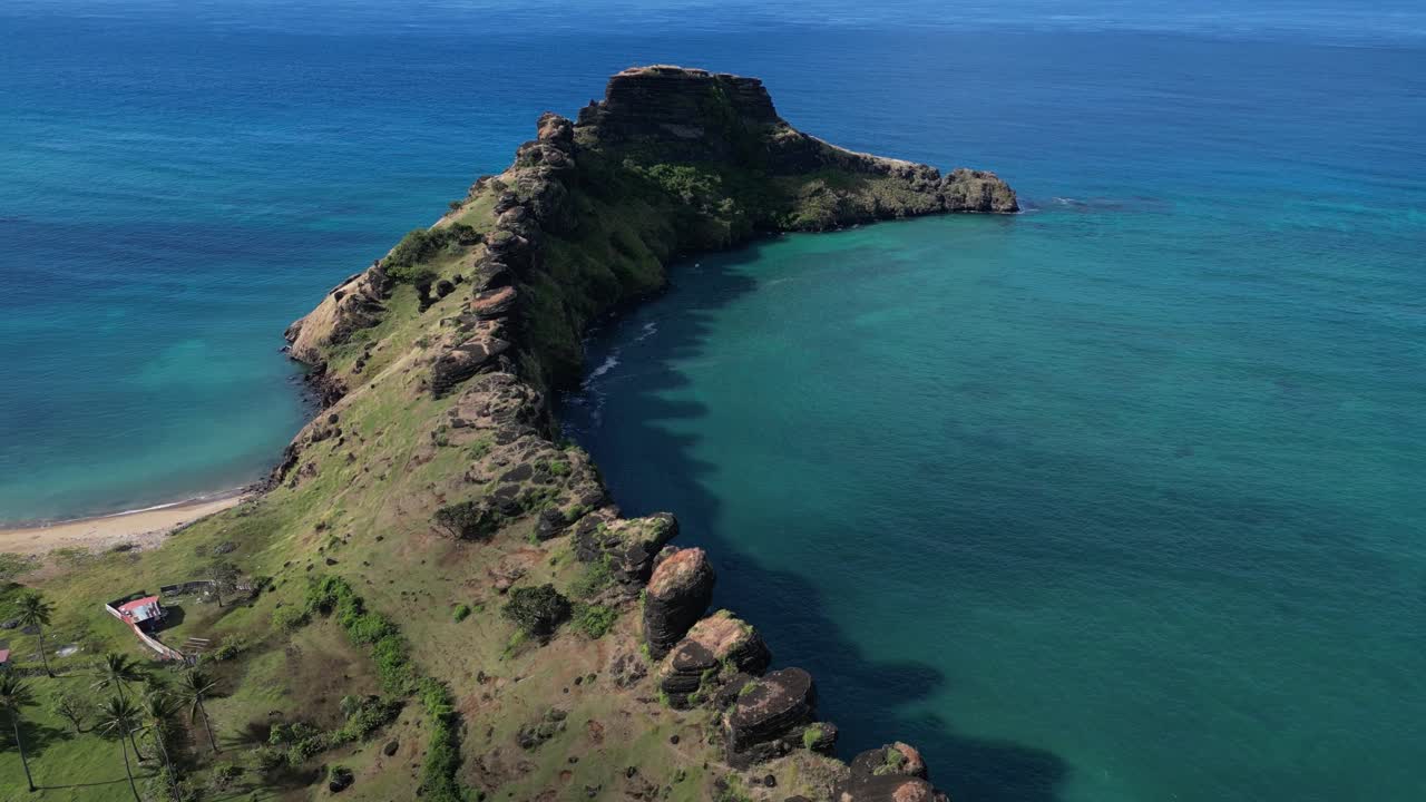 Coastal Aerial View Of Oceanfront Dragon's Back Volcanic Rock Formation, Comoros Islands, Drone Ascending View
