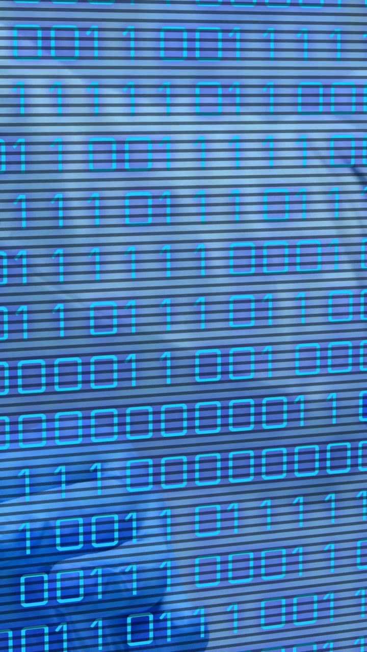 Animation of binary code over hands of lab workers