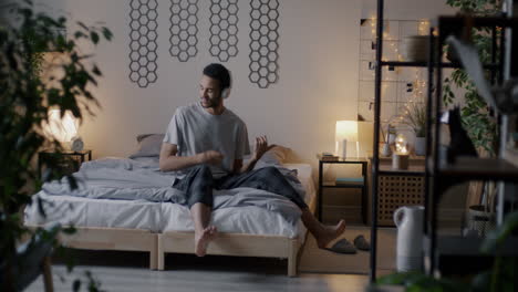 man listening to music in bed