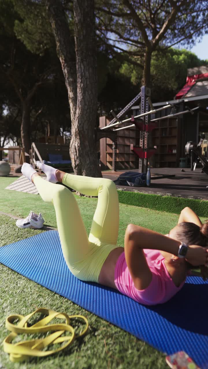 Woman exercising outdoors on a mat