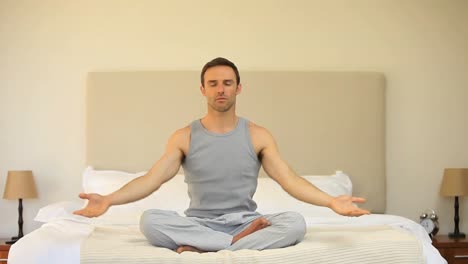 Man-doing-yoga-in-the-bedroom