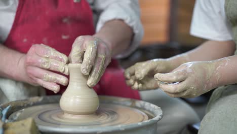 potter teaching pottery little girl