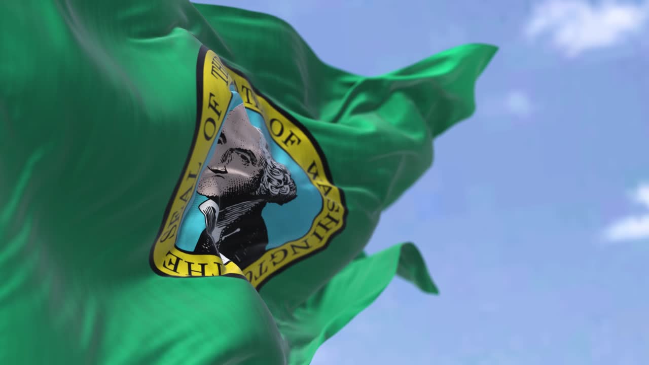 la bandera del estado de estados unidos de washington ondeando en el viento