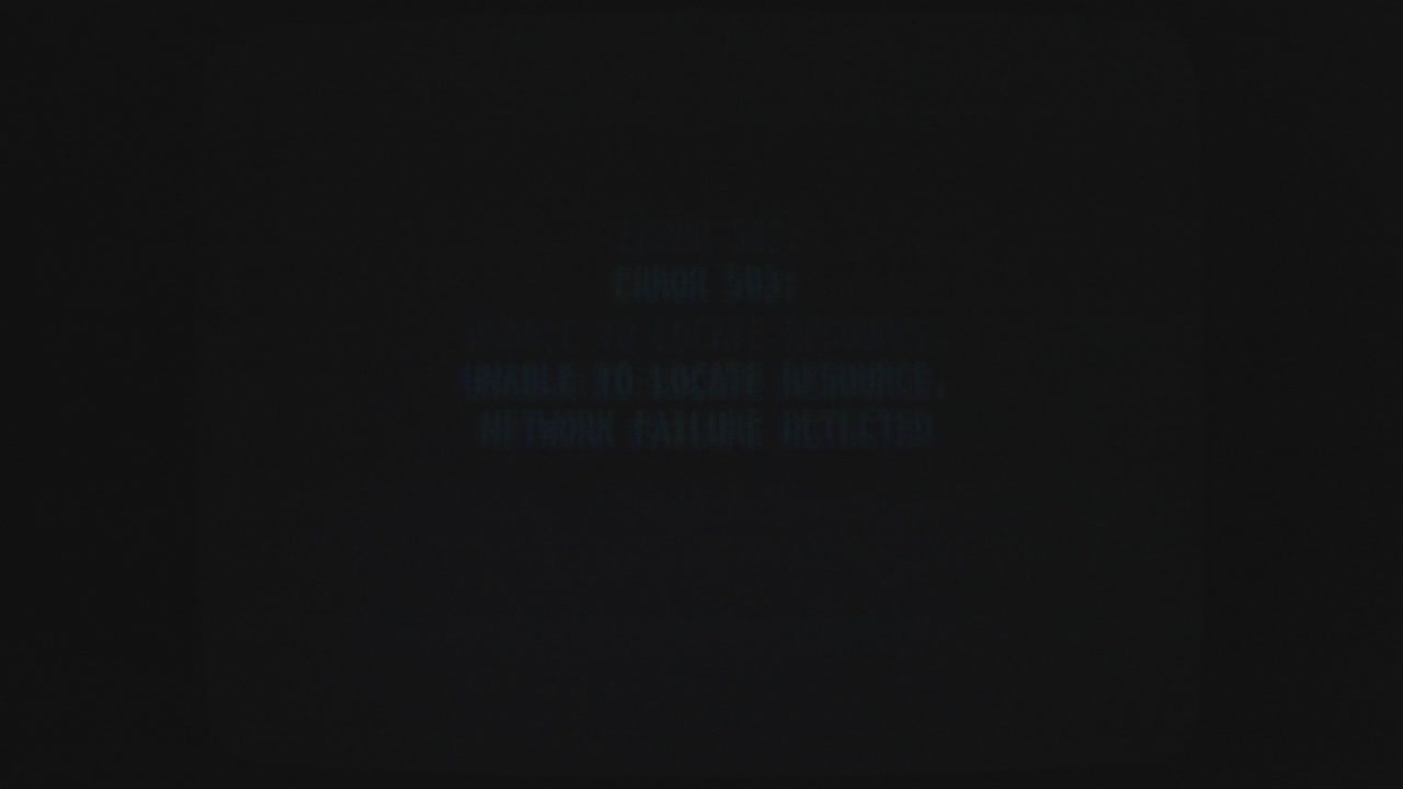 Computer screen displaying code language due to system problem. Flickering.