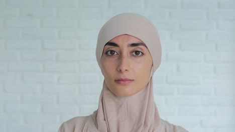 portrait of beautiful muslim woman in beige traditional hijab, natural beauty and feminity power. the beauty of a woman cannot be hidden under a hijab and under the yoke of the islamic world