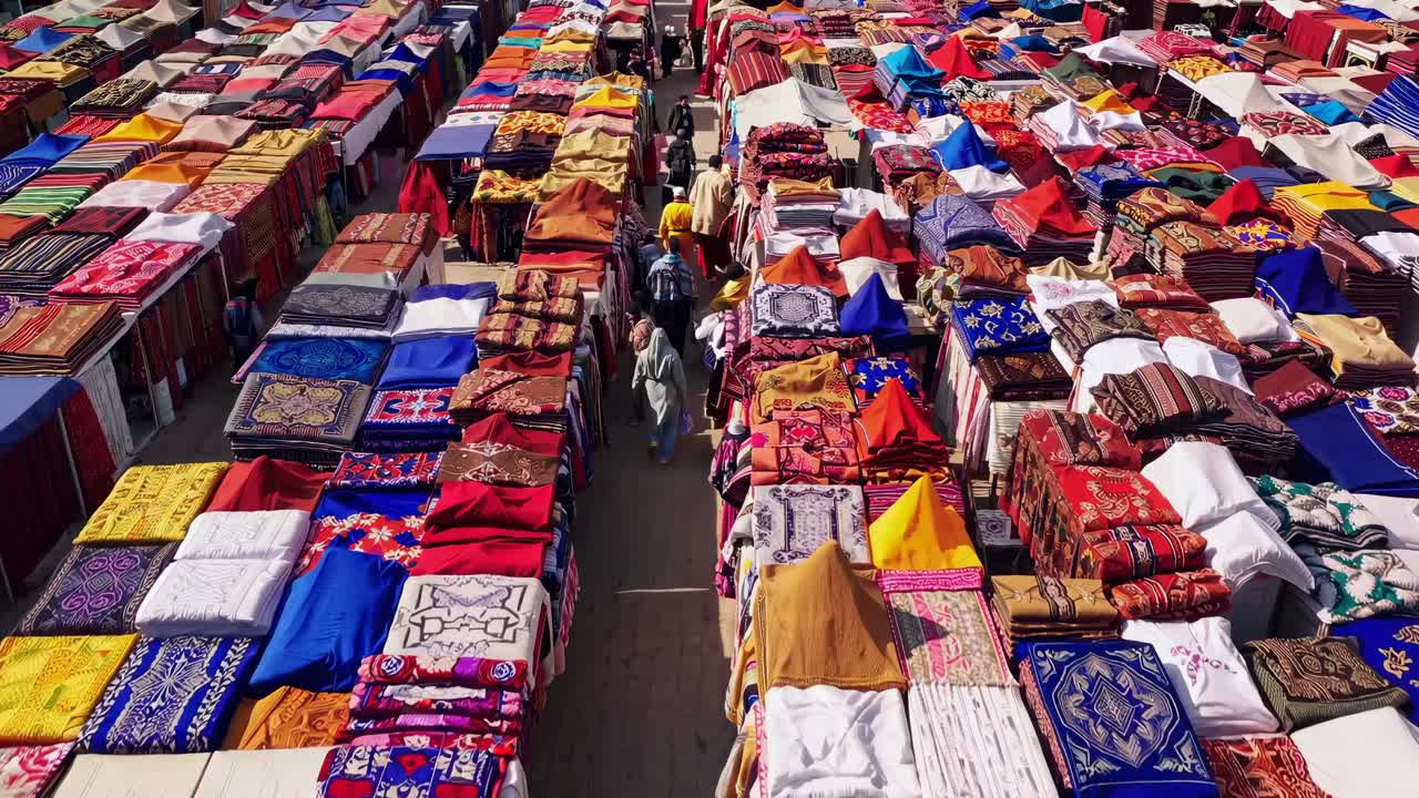 Aerial view video of a vibrant market with colorful textiles