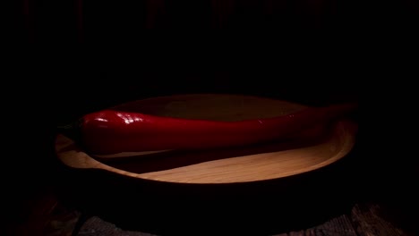 red chili pepper on wooden plate