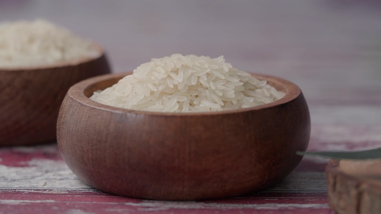 Uncooked White Rice in Wooden Bowls on a Rustic Table