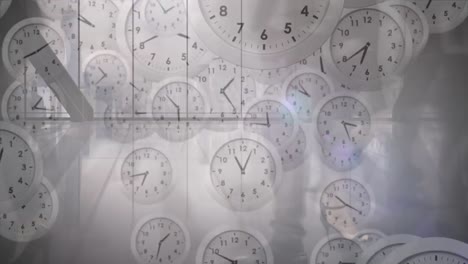 animation of multiple ticking clocks falling against time-lapse of businesspeople walking at office