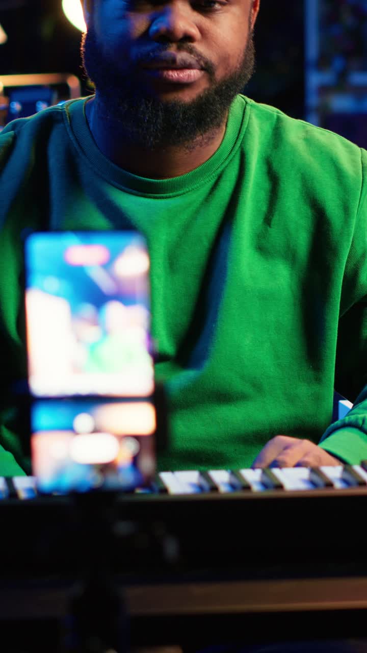 African American Man Recording Video with Smartphone and Keyboard