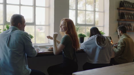 group of diverse friends drinking coffee together in cafe talking having conversation enjoying socializing on lunch break in restaurant shop