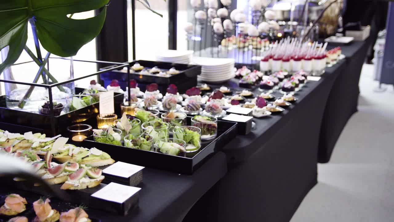 Professional catering during modern event cheese cake pudding on black tablecloth shoot on gimbal slider