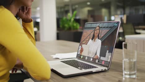 African-american-businesswoman-using-laptop-for-video-call-with-biracial-business-colleague