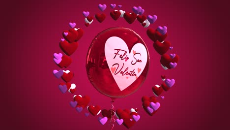 high quality seasonal motion graphic celebrating st valentine's day, with pink and red color scheme, balloon and a circle of spinning love hearts - spanish message "feliz san valentin