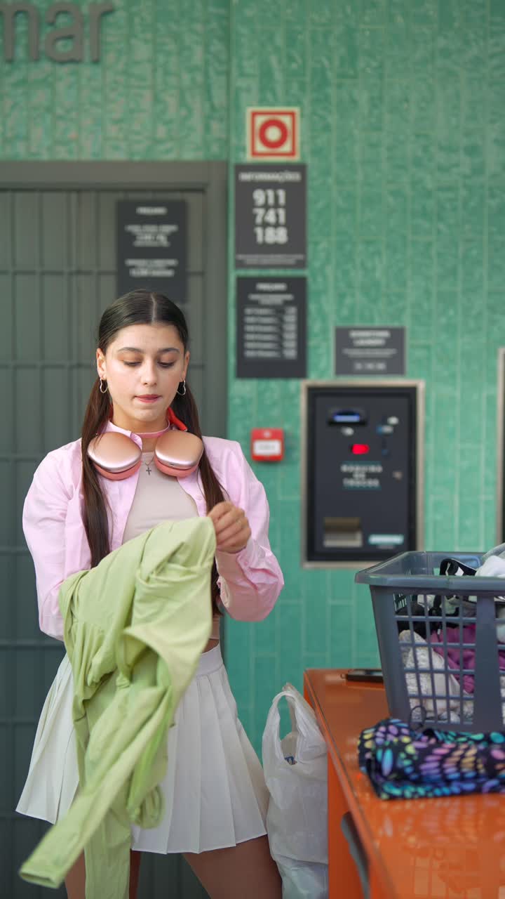 Young Woman Doing Laundry at a Laundromat