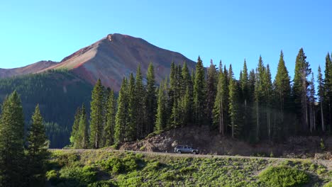 cars driving on the million dollar highway in the san juan mountains