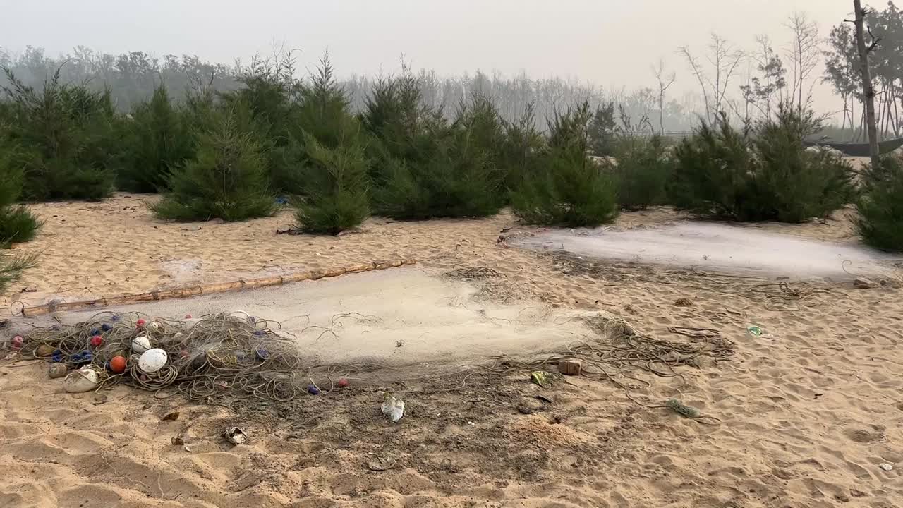 Manual fishing nets kept to dry after fishing by fisherman on sea beach in Bengal, India