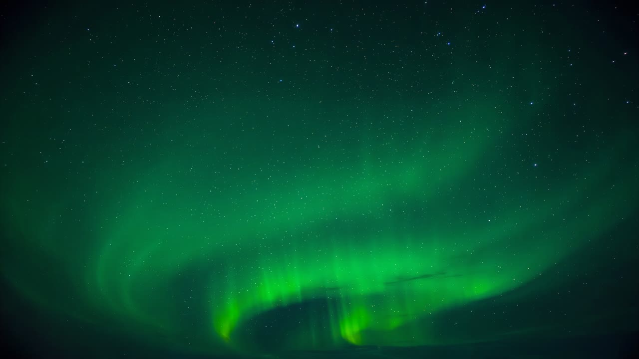 Entering upper-right band sweeping, auroral bands curling across polar sky, central pillar glowing
