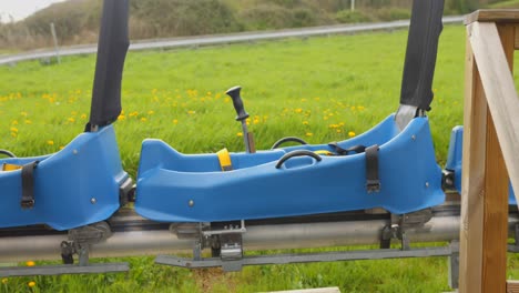 The-blue-sleds-of-an-Alpine-Coaster-together-at-the-start-of-the-descent