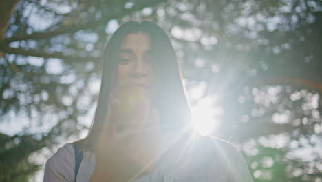 woman eating apple park standing at sunlight closeup. smiling beautiful lady