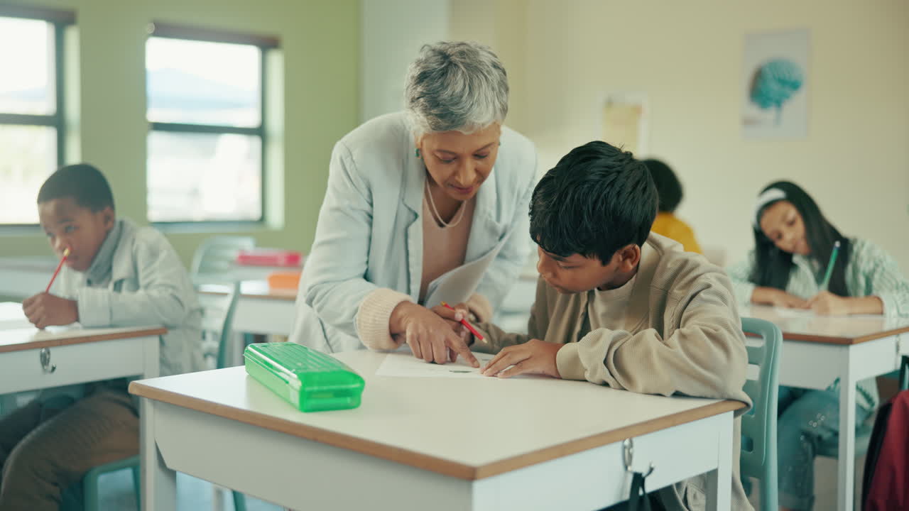 A teacher helping students in a classroom
