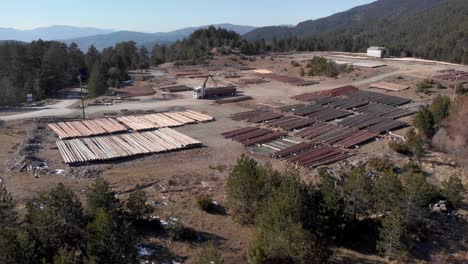 Vista-Aérea-Del-Agarrador-De-Troncos-Entre-El-Día-Del-Aserradero-De-Camiones-De-Carga-De-Madera