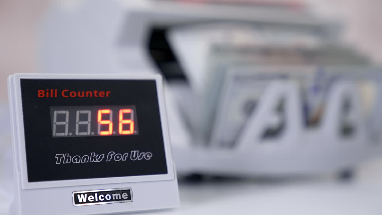 Automatic mechanism for bank financial operations. Electronic equipment shows the amount of money on the device during counting paper banknotes.