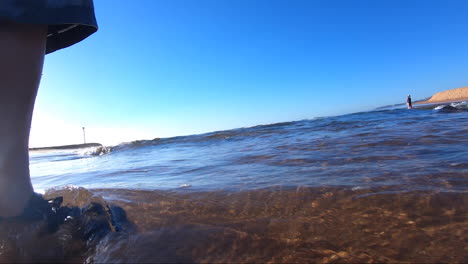 POV-from-within-the-surf-being-buffeted-around-within-the-waves-surrounded-by-sand-and-bubbles-and-wave-froth