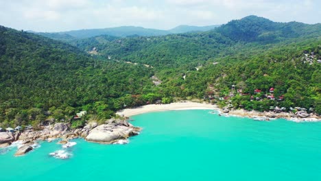 beautiful tropical island with green hills full of rainforest, secret white sandy beach and cliffs on shore washed by turquoise lagoon, thailand