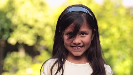 8-year-old-little-girl-on-green-bokeh-background