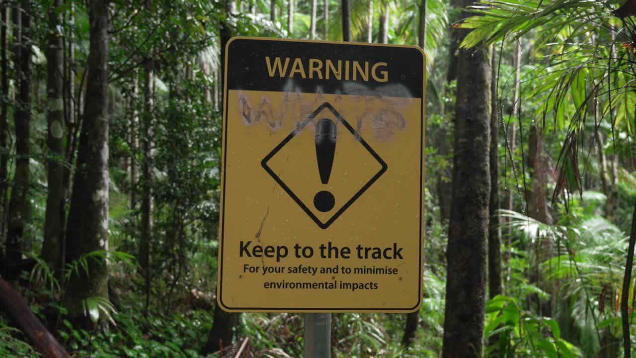 Warning Keep to the track yellow sign in Wollumbin National Park Australia